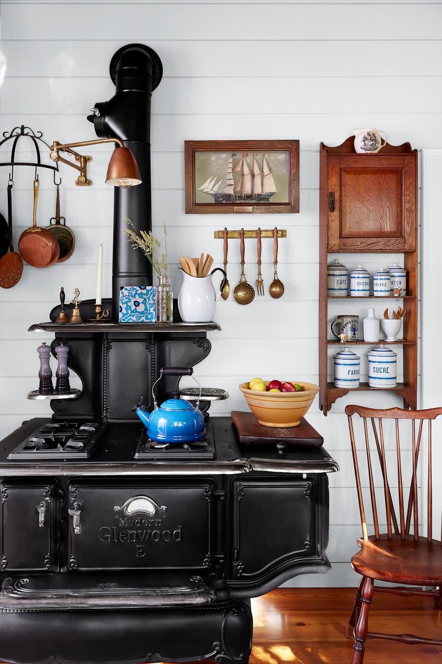 kitchen wall painted white, vintage wood burning stove, wall mounted spice rack