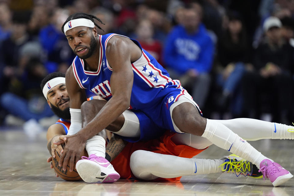 Philadelphia 76ers' Buddy Hield, top, and Oklahoma City Thunder's Kenrich Williams struggle for the ball during the second half of an NBA basketball game, Tuesday, April 2, 2024, in Philadelphia. (AP Photo/Matt Slocum)