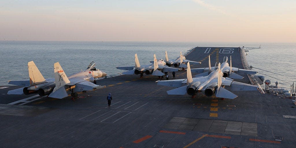 Chinese J-15 fighter jets waiting on the deck of the Liaoning aircraft carrier