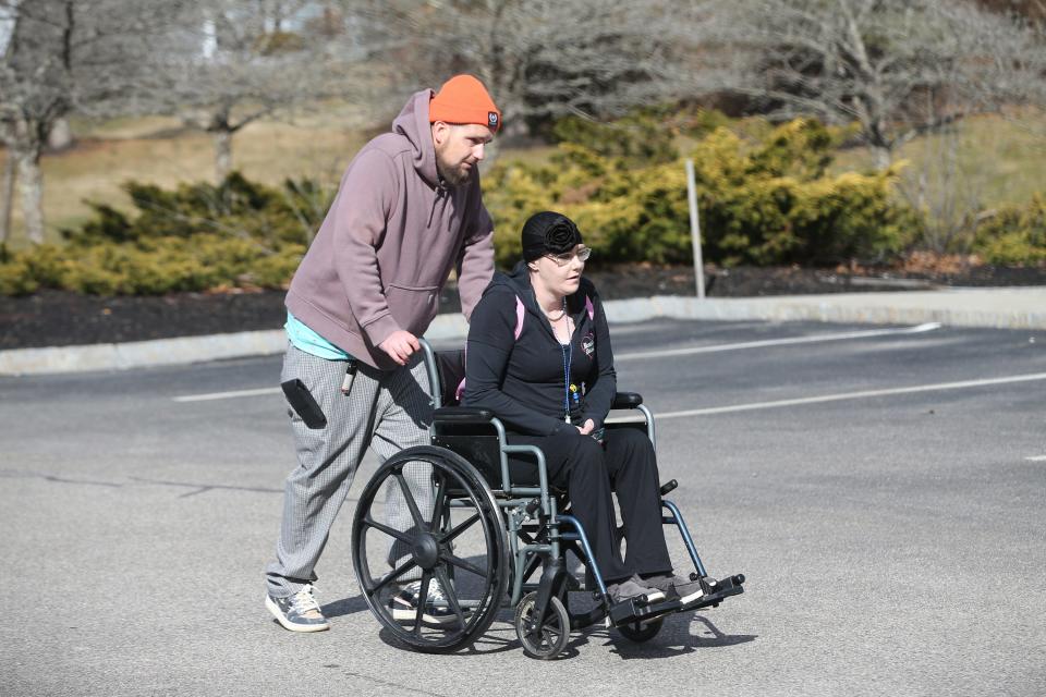 Hospice patient Carmelita Edgecomb gets wheeled back to her room by her friend, Michael as he visits her at Gosnell Memorial Hospice House March 18, 2024.