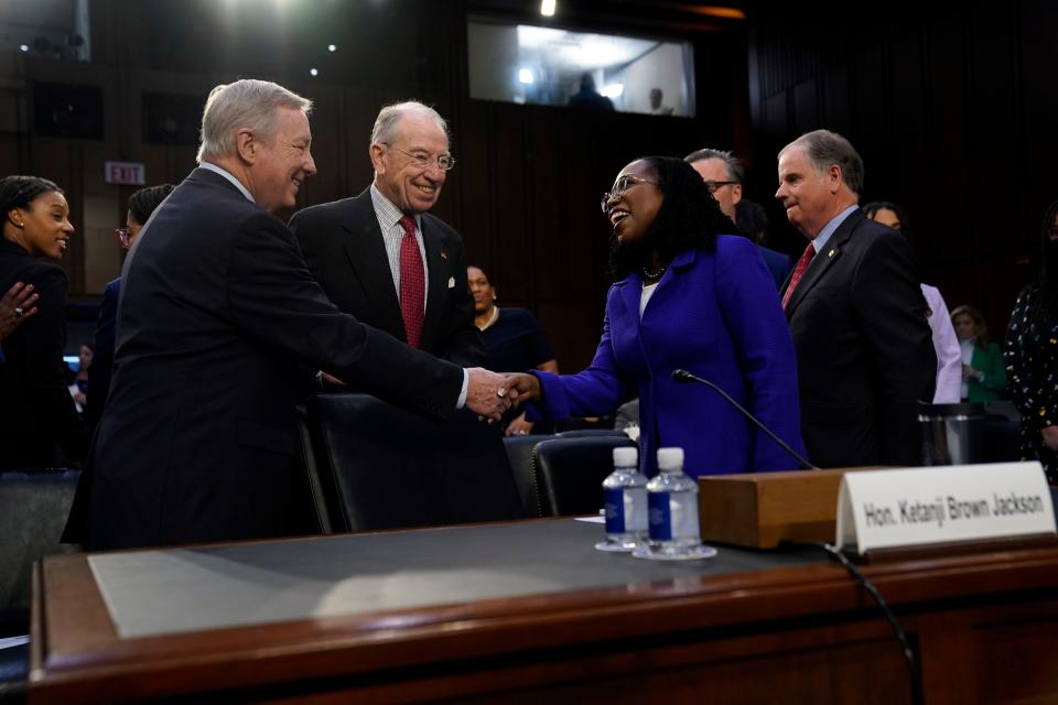 Senate Judiciary Committee Chairman Richard Durbin, left,, D-Ill., and ranking member Sen. Charles Grassley, R-Iowa, greet Supreme Court Associate Justice nominee Ketanji Brown Jackson as she appears before the Senate Judiciary Committee during her confirmation hearing on March 21, 2022, in Washington.