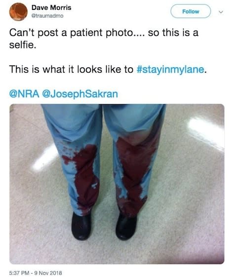 A doctor shows their bloodied scrubs, as medical staff respond to NRA's tweet  - Credit: Reuters / Twitter