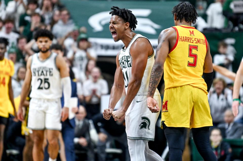 Michigan State's A.J. Hoggard, left, celebrates after scoring as Maryland's DeShawn Harris-Smith heads to the bench during a timeout in the second half on Saturday, Feb. 3, 2024, at the Breslin Center in East Lansing.