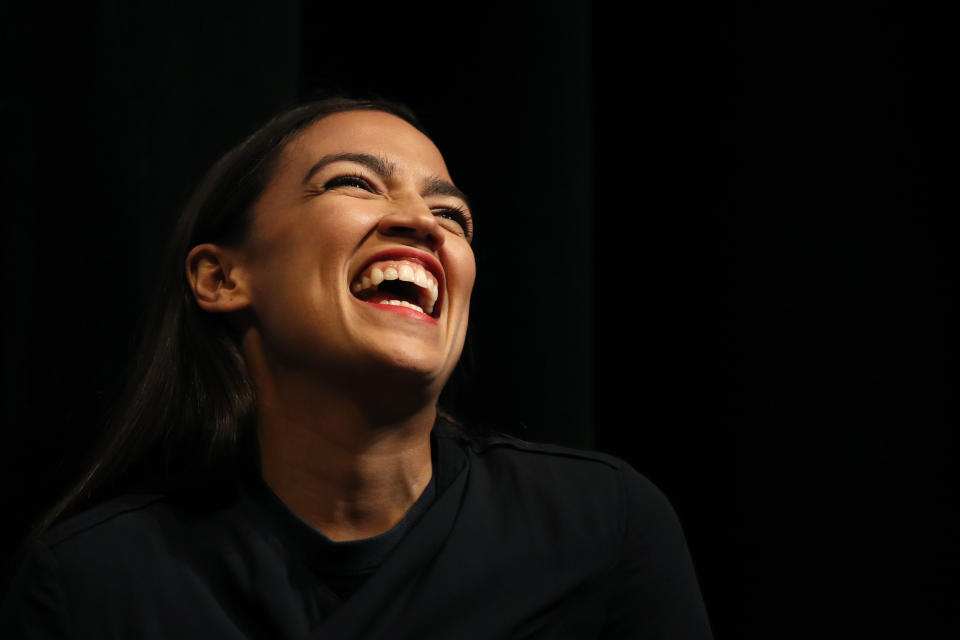 New York congressional candidate Alexandria Ocasio-Cortez laughs while listening to a speaker at a fundraiser Thursday, Aug. 2, 2018, in Los Angeles. The 28-year-old startled the party when she defeated 10-term U.S. Rep. Joe Crowley in a New York City Democratic primary. (AP Photo/Jae C. Hong)