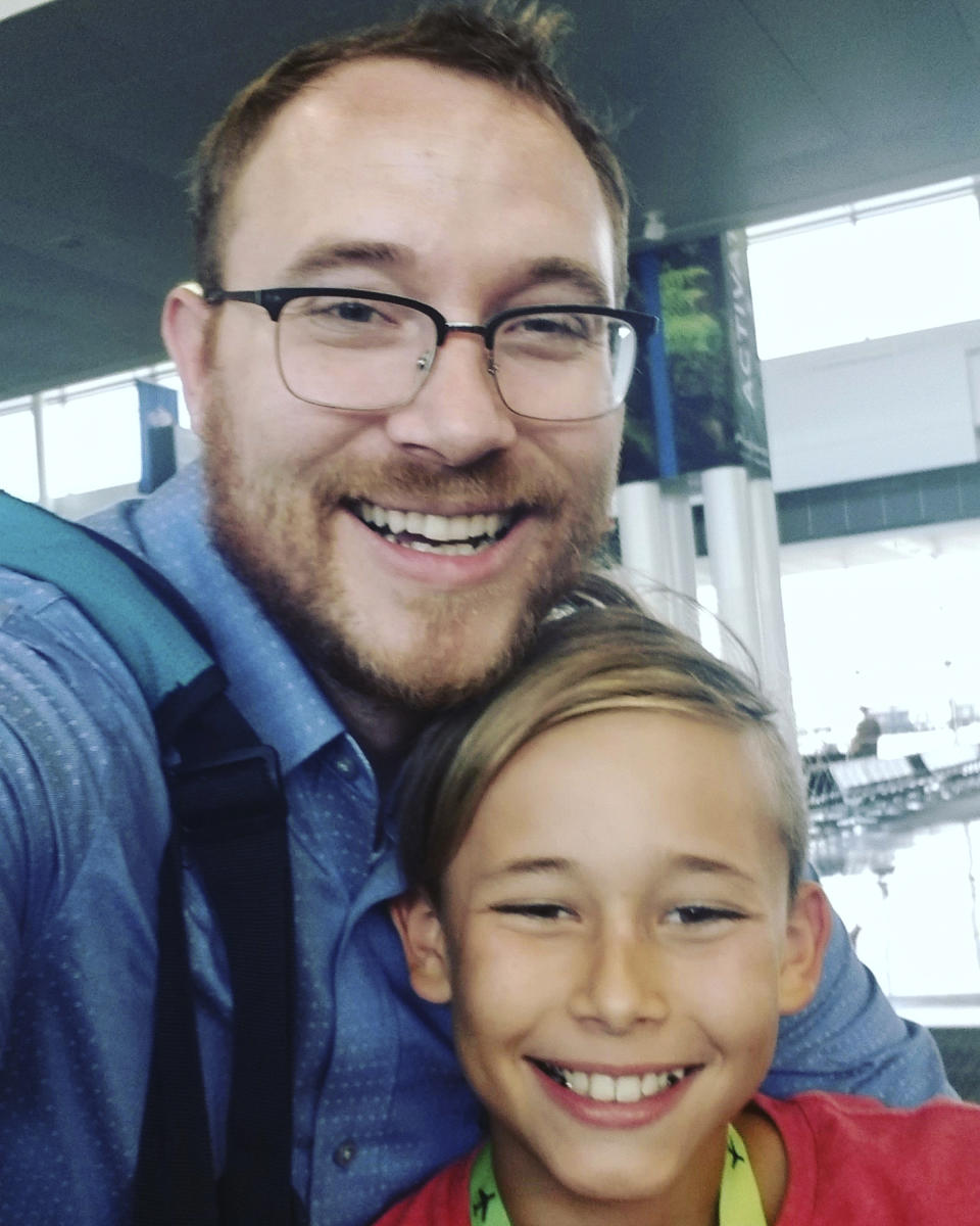 In this July 26, 2019, selfie provided by T.J. Sjostrum shows himself with his son Nolan at the Dulles International Airport in Dulles, Va., after his son flew over for the summer. The coronavirus is wreaking havoc on divorced families' custody arrangements as parents get sick or exposed to the illness. Sjostrum, a 36-year-old researcher in Virginia, said he was getting ready to pick up his 10-year-old son when his ex-wife said she wanted the boy to stay with her for the duration of the stay-at-home order. He said he had already been waiting for a court hearing to revisit their custody plan and now doesn't know when he'll get one. (T.J. Sjostrom via AP)