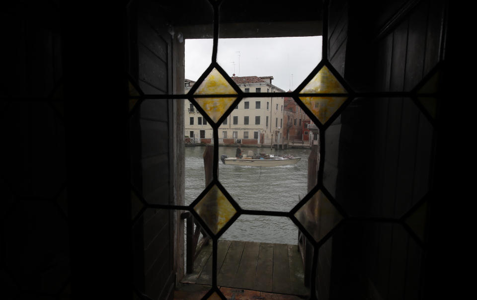 In this picture taken on Wednesday, May 13, 2020, a view through a window of a boat in Canal grande (Grand Canal) in Venice, Italy. Venetians are rethinking their city in the quiet brought by the coronavirus pandemic. For years, the unbridled success of Venice's tourism industry threatened to ruin the things that made it an attractive destination to begin with. Now the pandemic has ground to a halt Italy’s most-visited city, stopped the flow of 3 billion euros in annual tourism-related revenue and devastated the city's economy. (AP Photo/Antonio Calanni)