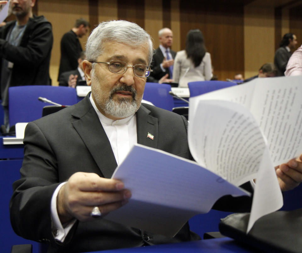 Iran's ambassador to the International Atomic Energy Agency, IAEA, Ali Asghar Soltanieh checks his papers prior to the start of the IAEA board of governors meeting at the International Center, in Vienna, Austria, on Thursday, March 8, 2012. (AP Photo/Ronald Zak)