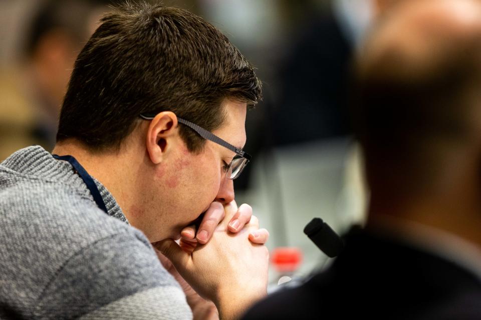 Ottawa County Board of Commissioners Chair Joe Moss bows his head in prayer before a meeting Tuesday, Jan. 10.