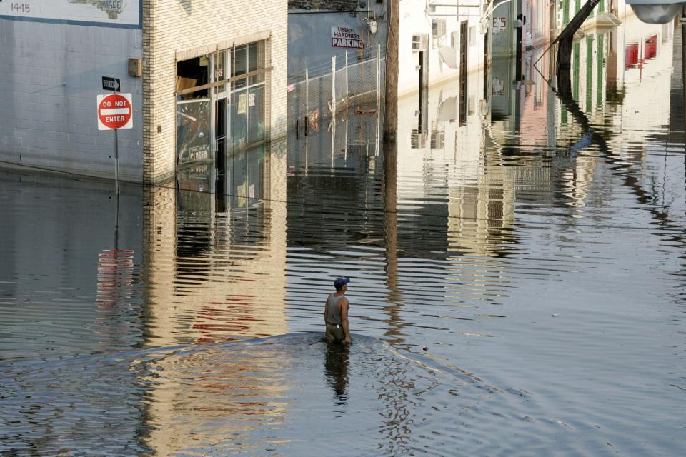 A lone man wades through the floodwaters in New Orleans north of downtown six days after Hurricane Katrina passed through the area.