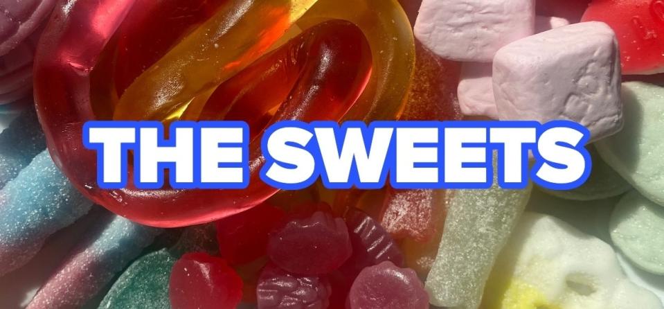 Various colorful gummy candies with the words "THE SWEETS" in bright blue bold text across the center