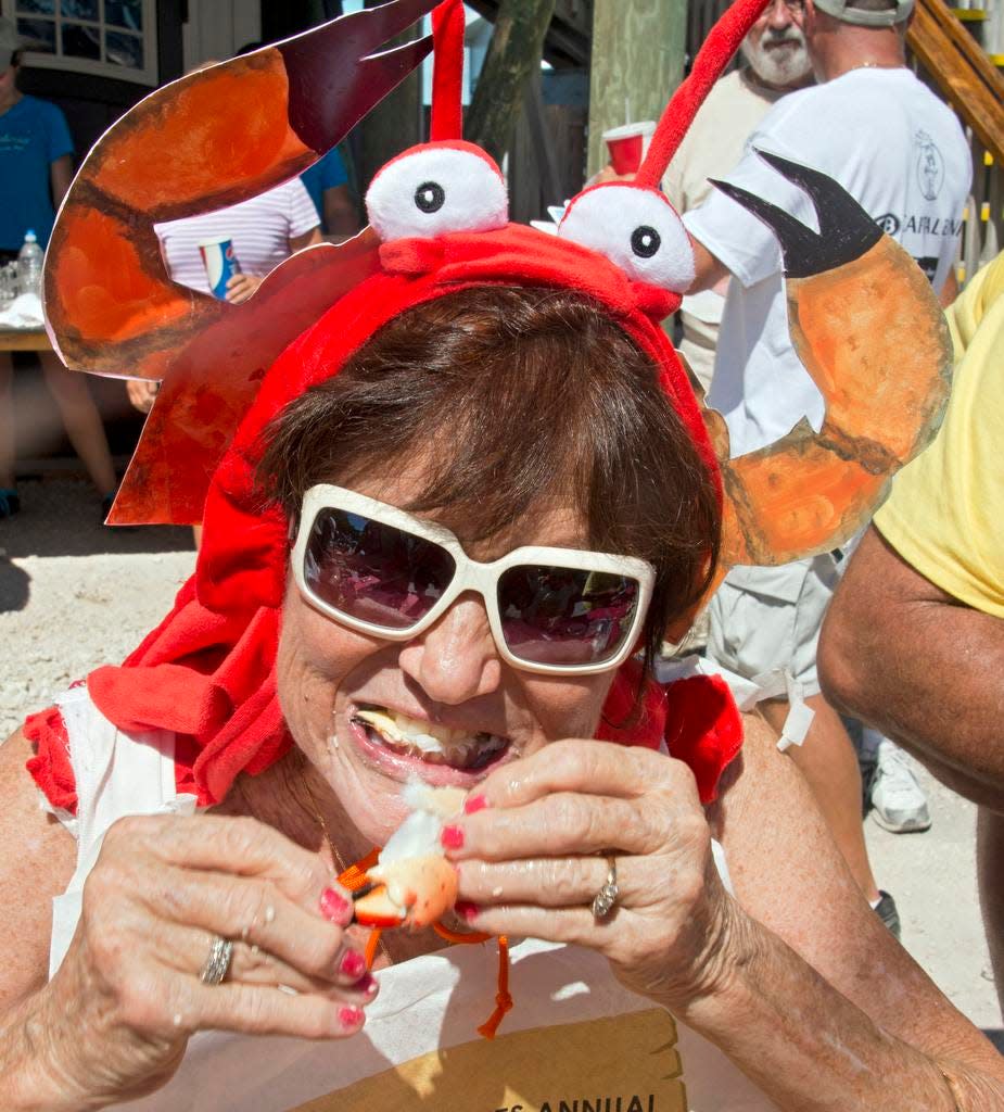 Sandra Bradshaw chomps on a stone crab claw Oct. 18, 2014, during the Keys Fisheries Stone Crab Eating Contest in Marathon, Fla.