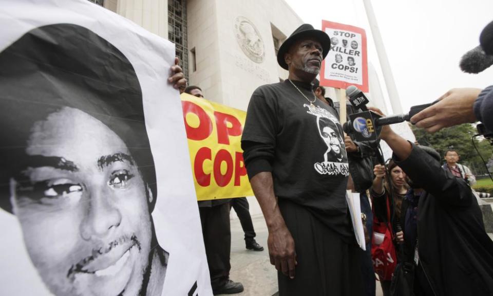 Cephus Johnson, known as Uncle Bobby X, stands on court steps in Los Angeles protesting against the release of Johannes Mehserle in 2011.