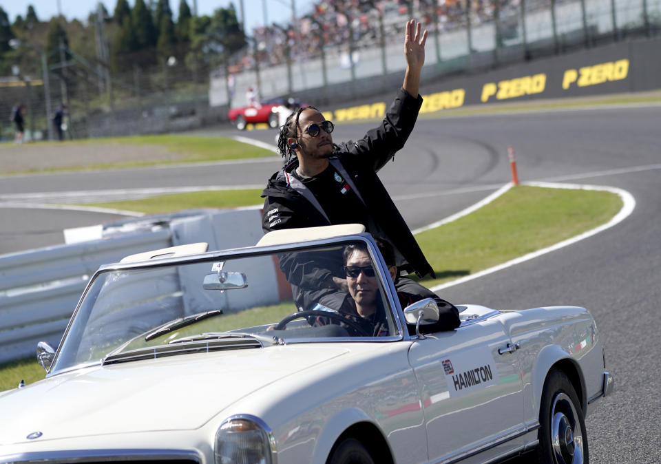 Mercedes driver Lewis Hamilton of Britain waves to the crowd during the drivers parade ahead of the Japanese Formula One Grand Prix at Suzuka Circuit in Suzuka, central Japan, Sunday, Oct. 13, 2019. (AP Photo/Toru Hanai)