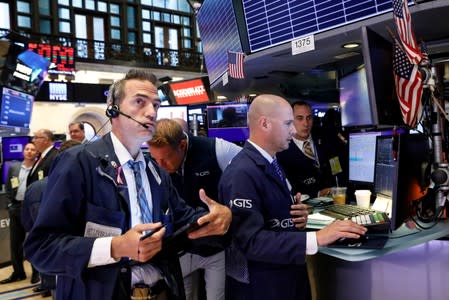 Traders work on the floor at the NYSE in New York