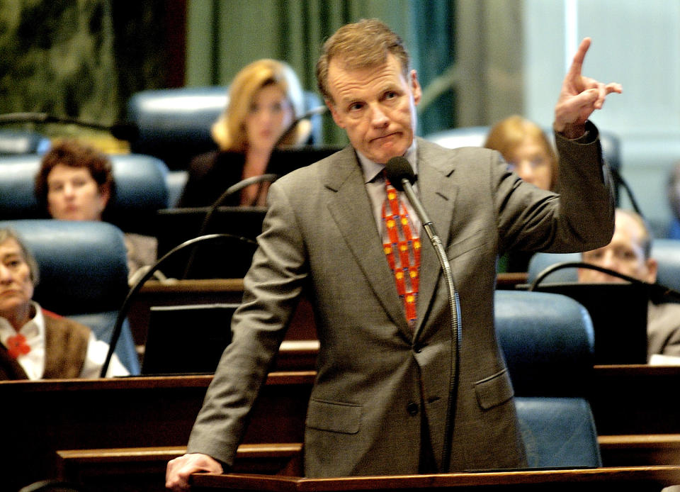 FILE - Then-Illinois Speaker of the House Michael Madigan, D-Chicago, argues government ethics legislation while on the House of Representatives floor during session at the Illinois State Capitol in Springfield, Ill., on Nov. 4, 2003. Madigan, the former speaker of the Illinois House and for decades one of the nation’s most powerful legislators, was charged with racketeering and bribery on Wednesday March 2, 2022, becoming the most prominent politician swept up in the latest federal investigation of entrenched government corruption in the state. (AP Photo/Seth Perlman File)