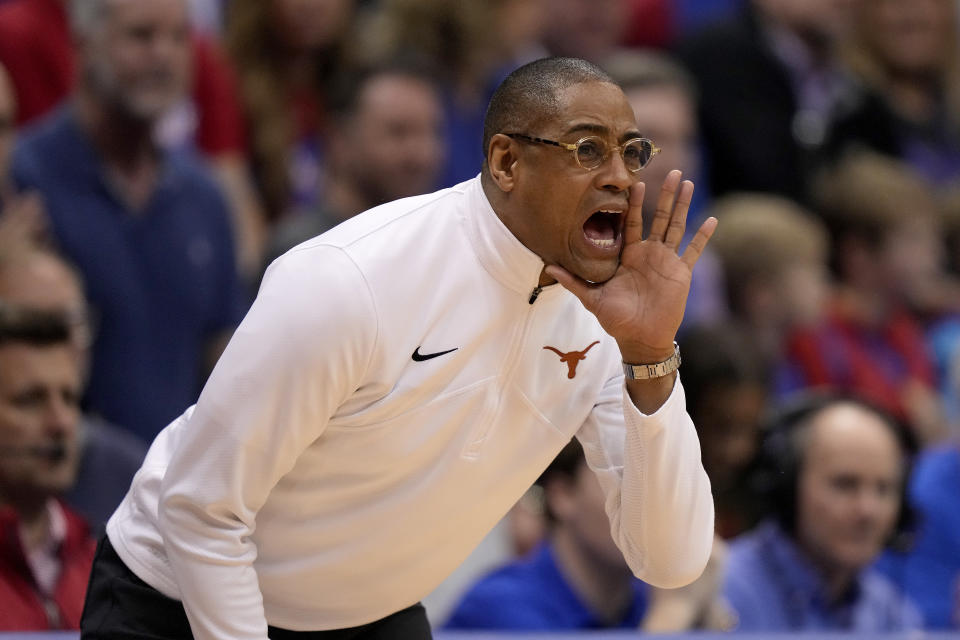 Interim Texas head coach Rodney Terry talks to his players during the first half of an NCAA college basketball game against Kansas Monday, Feb. 6, 2023, in Lawrence, Kan. (AP Photo/Charlie Riedel)