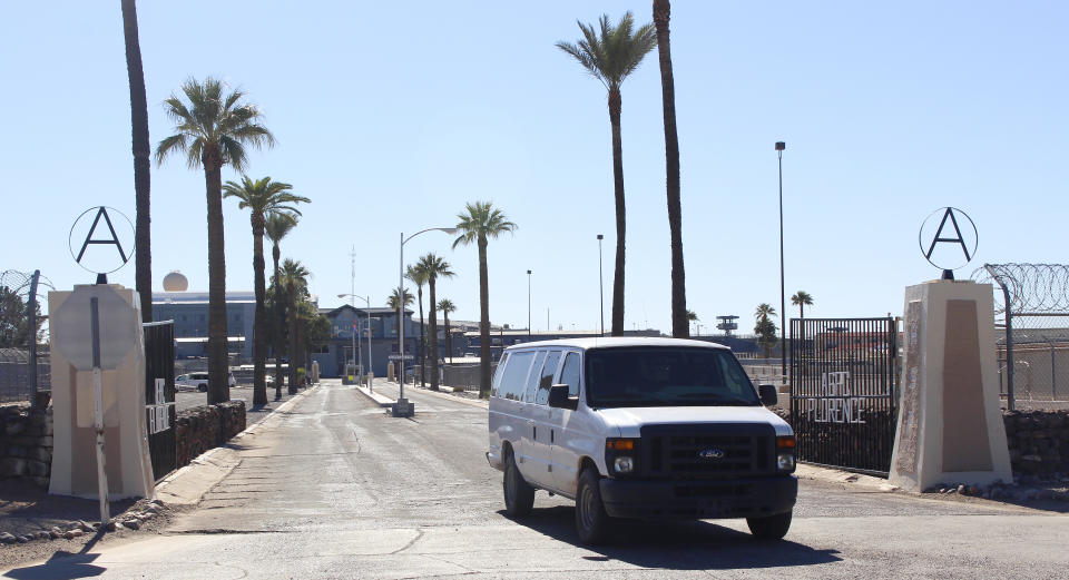 State prison vehicles are shown at the main entrance to the Arizona State Prison Complex-Florence, in Florence, Ariz., on Wednesday, Nov. 16, 2022, shortly after prisoner Murray Hooper was executed in the facility's death chamber for the murders of a man and woman in 1980. The execution was the third of the year at the prison. (AP Photo/Bob Christie)