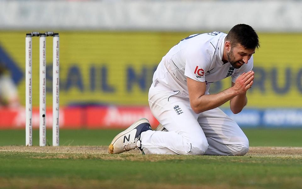 Mark Wood praying on the pitch