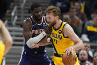 Indiana Pacers' Domantas Sabonis (11) is defended by Phoenix Suns' Deandre Ayton (22) during the second half of an NBA basketball game, Friday, Jan. 14, 2022, in Indianapolis. (AP Photo/Darron Cummings)