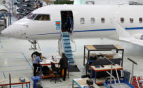 Technicians work on a Bombardier Global aircraft at the company's service centre at Biggin Hill, Britain March 5, 2018. REUTERS/Peter Nicholls