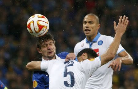 Dnipro Dnipropetrovsk's Yevhen Seleznyov (L) goes for a header with Napoli's Miguel Britos (front) during their Europa League semi-final second leg soccer match at the Olympic stadium in Kiev, Ukraine, May 14, 2015. REUTERS/Valentyn Ogirenko