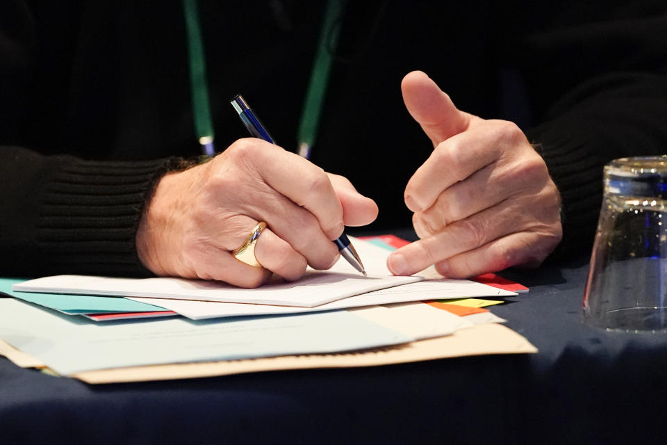 Bishop Donald Hanchon, of Detroit, jots down notes during the Fall General Assembly meeting of the United States Conference of Catholic Bishops, Tuesday, Nov. 16, 2021, in Baltimore.(AP Photo/Julio Cortez)