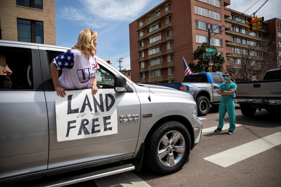 Health care workers stand in the street in counter-protest to hundreds of people who gathered at the state Capitol to demand the stay-at-home order be lifted in Denver. (Photo: REUTERS/Alyson McClaran)