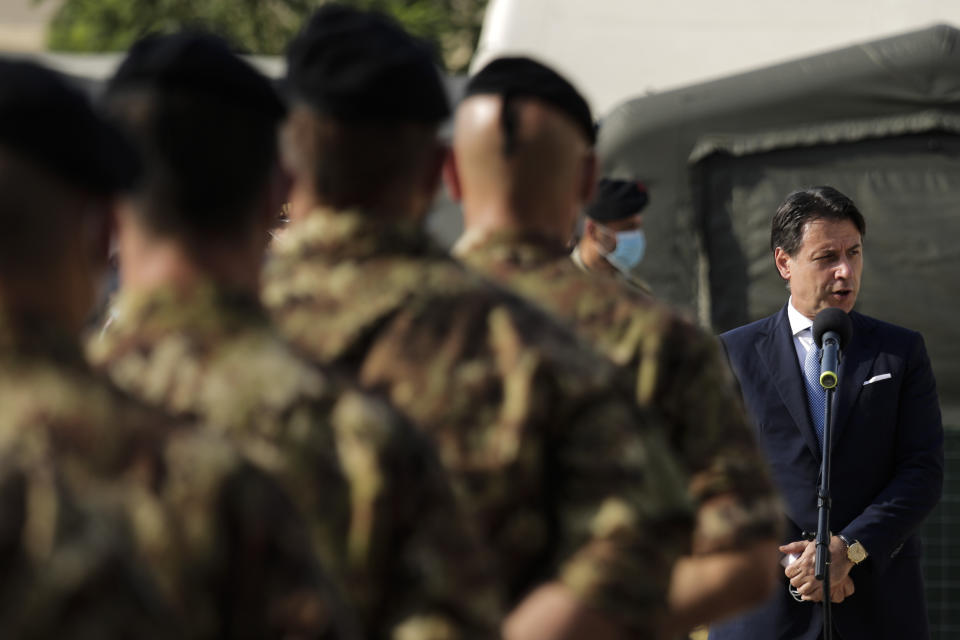 Italian Prime Minister Giuseppe Conte, right, addresses Italian soldiers as he visits an Italian field hospital set up at the Lebanese University in the Hadath district of Beirut, Lebanon, Tuesday, Sept. 8, 2020. Conte said Tuesday his country will support Lebanon's economic and social growth, expressing hopes that a new government is formed quickly — one that would start the reconstruction process in the wake of last month's Beirut explosion and implement badly needed reforms. (AP Photo/Hassan Ammar)