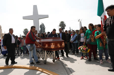 Relatives and friends carry the coffin of Cesar Jimenez Brito, 40, who died during the explosion of a fuel pipeline ruptured by suspected oil thieves, outside a church in the municipality of Tlahuelilpan, state of Hidalgo, Mexico January 20, 2019. REUTERS/Henry Romero