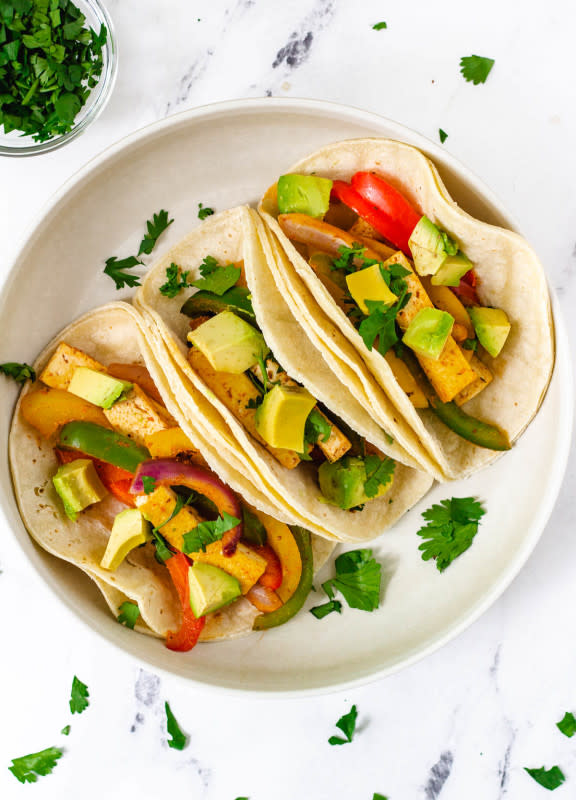 <p>Keeping the Peas</p><p>Tofu fajitas are a simple and flavorful vegan dinner you can make in under 30 minutes. With an assortment of spices these fajitas are smoky, and packed with tons of protein, vitamins and minerals!</p><p><strong>Get the recipe: <a href="https://www.keepingthepeas.com/tofu-fajitas/" rel="nofollow noopener" target="_blank" data-ylk="slk:Tofu Fajitas;elm:context_link;itc:0;sec:content-canvas" class="link "><em>Tofu Fajitas</em></a></strong></p>