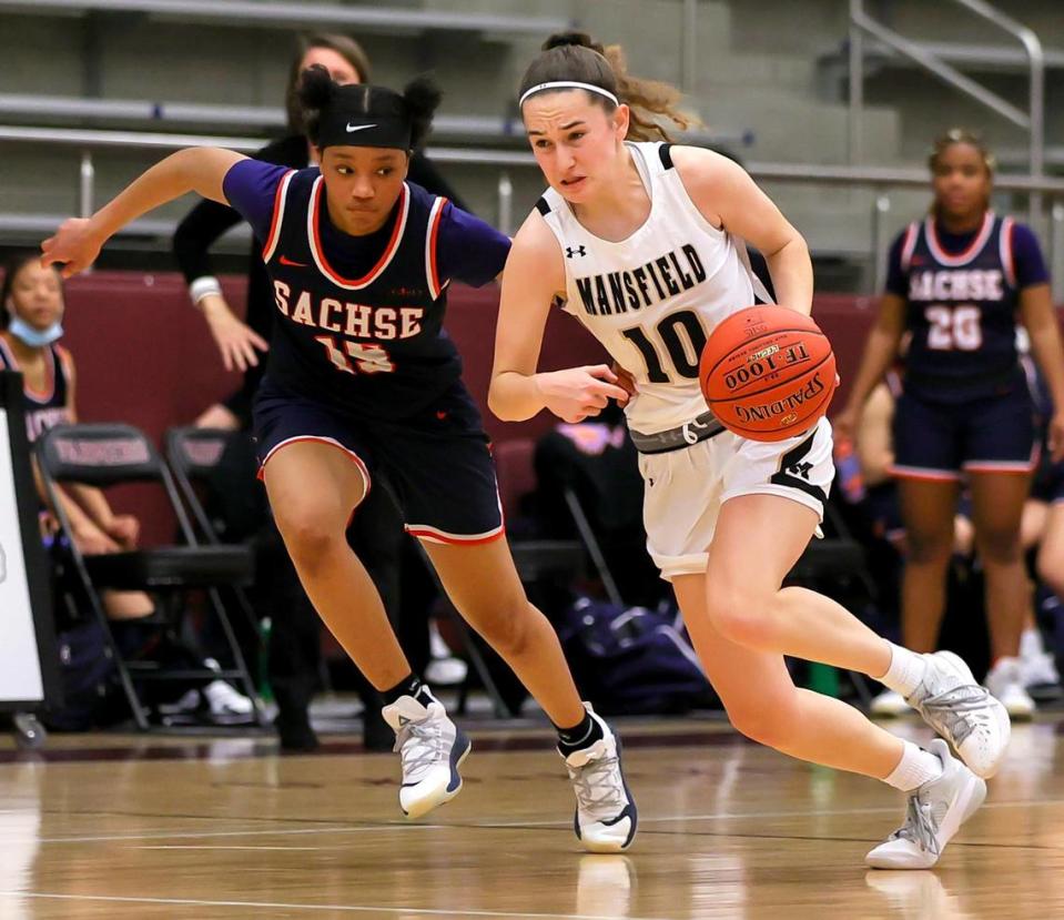 Mansfield guard Emily Holland (10) dribbles past Sachse guard Londyn Oliphant (15) during the second half of the 6A Region II Girls Basketball Area -Round 2 played February 23, 2021 at Lewisville High School. (Steve Nurenberg Special to the Star-Telegram)