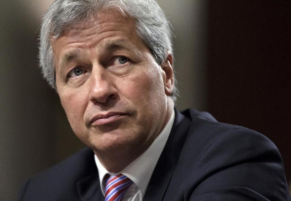 FILE- In this Wednesday, June 13, 2012, file photo, JPMorgan Chase CEO Jamie Dimon, head of the largest bank in the United States, testifies before the Senate Banking Committee on Capitol Hill in Washington. All eyes will be on JPMorgan Chase on Friday, when it becomes the first U.S. bank to report financial results for April through June. The $2 billion trading loss by the largest U.S. bank rattled the company's stock price, triggered a U.S. government investigation and hurt both its reputation and that of CEO Jamie Dimon. (AP Photo/J. Scott Applewhite, File)