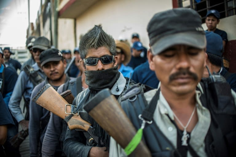 Members of a Mexican community police unit march in Tlacotepec, Guerrero state -- they are trying to protect locals from the scourge of drug violence and organized crime