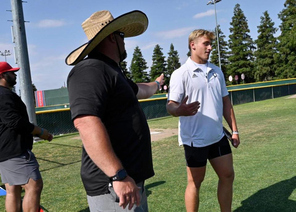 Clovis North track and field coach Rich Brazil, left, with McKay Madsen at the Boys Discus at the 2023 CIF California Track & Field State Championship qualifiers Friday, May 26, 2023 in Clovis.