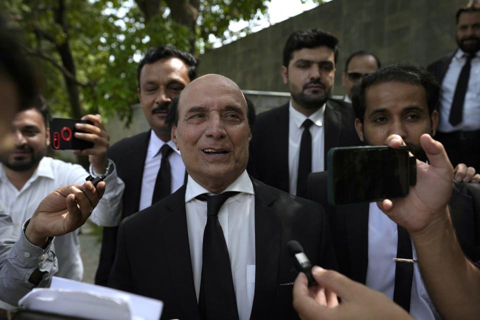 Latif Khoosa, center, a leading lawyer of imprisoned former Prime Minister Imran Khan's legal team, talks to media as he leaves the Islamabad High Court in Islamabad, Pakistan, Thursday, Aug. 24, 2023. A court in Pakistan's capital is likely to issue a crucial ruling Thursday on an appeal from the country's imprisoned former Prime Minister Khan against his recent conviction and three-year sentence in a graft case, one of his lawyers said. (AP Photo/Anjum Naveed)