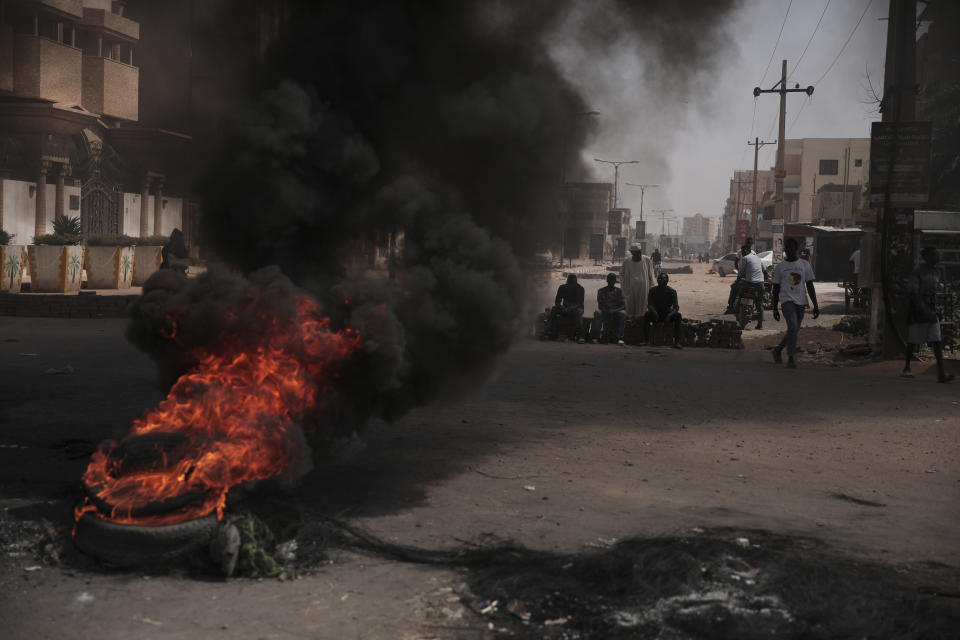 People burn tires during a protest a day after the military seized power Khartoum, Sudan, Tuesday, Oct. 26, 2021. The takeover came after weeks of mounting tensions between military and civilian leaders over the course and the pace of Sudan's transition to democracy. (AP Photo/Marwan Ali)