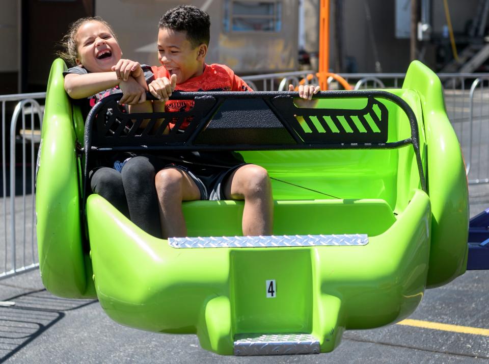 Olivia Wilson, 6, and Dominic Sheridan, 9, both of Henderson laugh together as they ride the Sizzler during the first day of the 32nd annual Tri-Fest in downtown Henderson, Ky., Friday, April 26, 2019. "He kept squishing me," Wilson said about Sheridan, when asked if she had fun on the ride. 