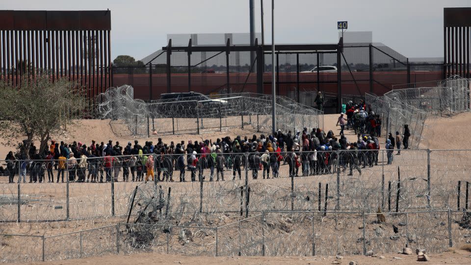 Migrants line up to be transferred by US Border Patrol after having crossed the Bravo River in El Paso, Texas, as seen from Ciudad Juarez, Chihuahua State, Mexico, on April 18, 2024. - Herika Martinez/AFP/Getty Images