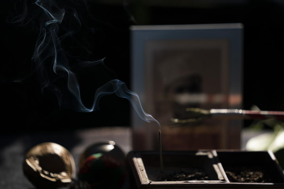 Smoke rises from an incense stick during a memorial service for Giichi Matsumura at Woodlawn Cemetery in Santa Monica, Calif., Monday, Dec. 21, 2020. Giichi Matsumura, who died in the Sierra Nevada on a fishing trip while he was at the Japanese internment camp at Manzanar, was reburied in the same plot with his wife 75 years later after his remains were unearthed from a mountainside grave. (AP Photo/Jae C. Hong)