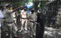 Police officers stand outside the residence of Bollywood icon Dilip Kumar in Mumbai, India, Wednesday, July 7, 2021. Dilip Kumar, hailed as the "Tragedy King" and one of Hindi cinema's greatest actors, died Wednesday in a Mumbai hospital after a prolonged illness. He was 98. (AP Photo/Rafiq Maqbool)
