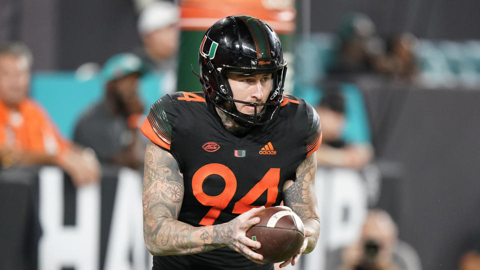 FILE - Miami punter Lou Hedley prepares to punt during the second half of an NCAA college football game against North Carolina State, Oct. 23, 2021, in Miami Gardens, Fla. Hedley is among thousands of international student athletes who can’t earn income from their name, image and likeness on U.S. soil. Some are trekking home to do it. Hedley had to fly 13,000 miles to western Australia to cash in on his name. (AP Photo/Wilfredo Lee, File)