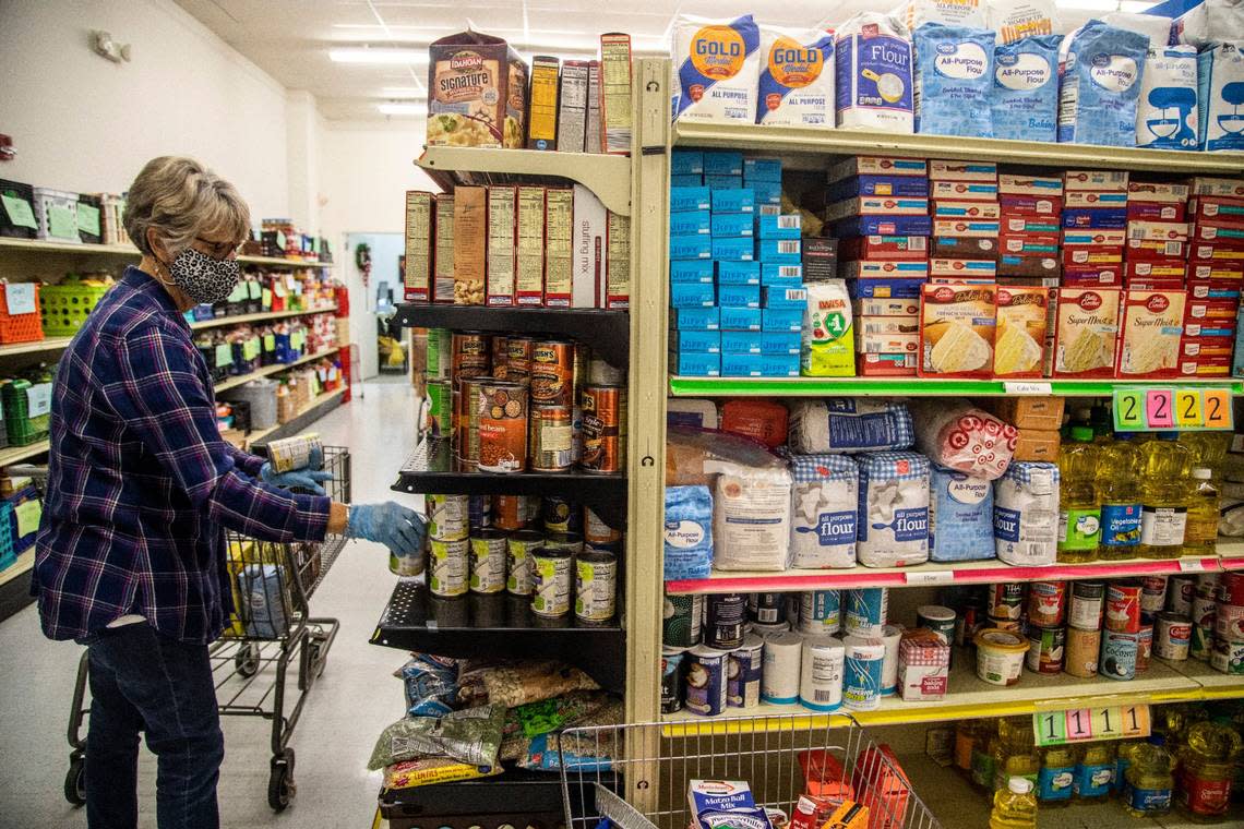 Carol Anne Moehring, a volunteer at Dorcas Ministries Food Pantry in Cary, gathers groceries for a family in need Friday, Dec. 18, 2020.