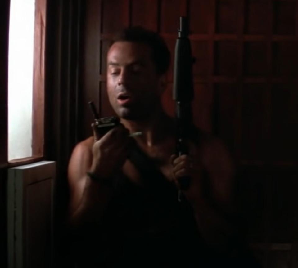 Bruce Willis as John McClane communicates with Hans via walkie-talkie in "Die Hard"