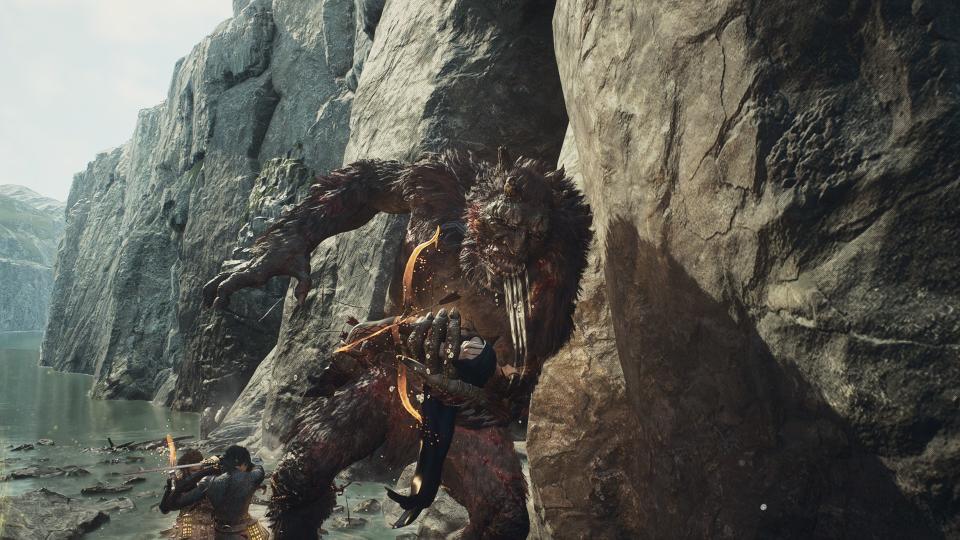An ogre salivating over an adventurer held in their hand in Dragon's Dogma 2.