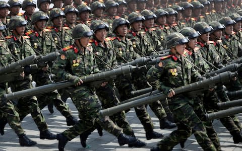 Soldiers carrying rockets march across Kim Il Sung Square during a military parade - Credit: AP