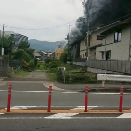 Social media video grab of smoke billowing from a fire at the Kyoto Animation studio in Kyoto