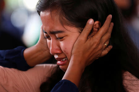 A relative of passengers on the crashed Lion Air flight JT610, cries at Bhayangkara R. Said Sukanto hospital in Jakarta, Indonesia, October 30, 2018. REUTERS/Willy Kurniawan