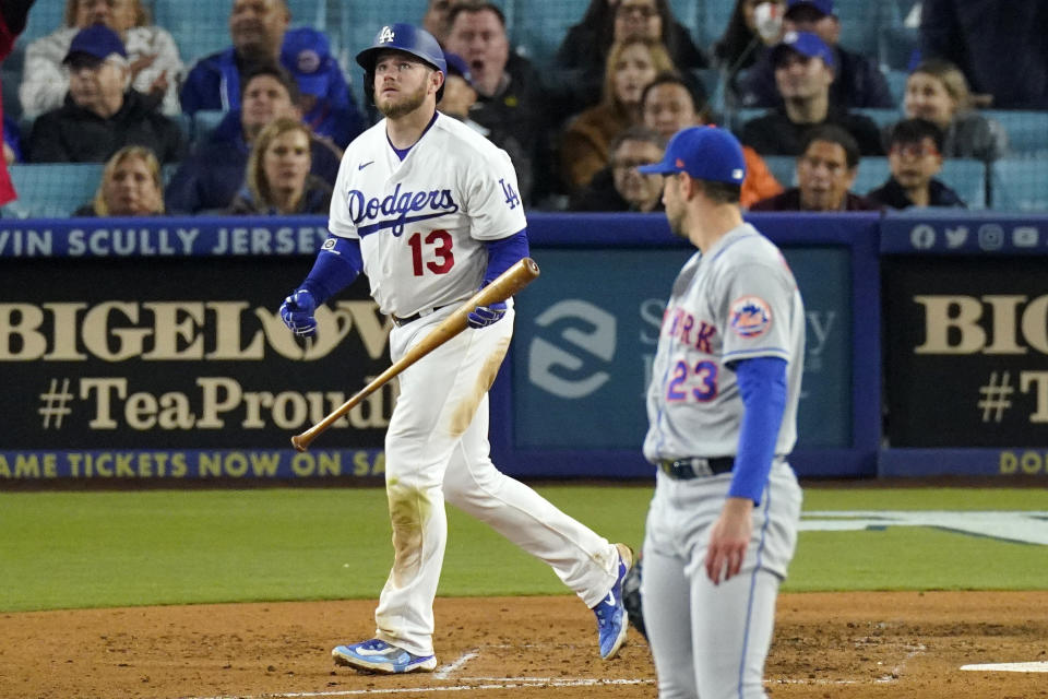Los Angeles Dodgers' Max Muncy, left, heads to first after hitting a solo home run as New York Mets starting pitcher David Peterson watches during the sixth inning of a baseball game Monday, April 17, 2023, in Los Angeles. (AP Photo/Mark J. Terrill)