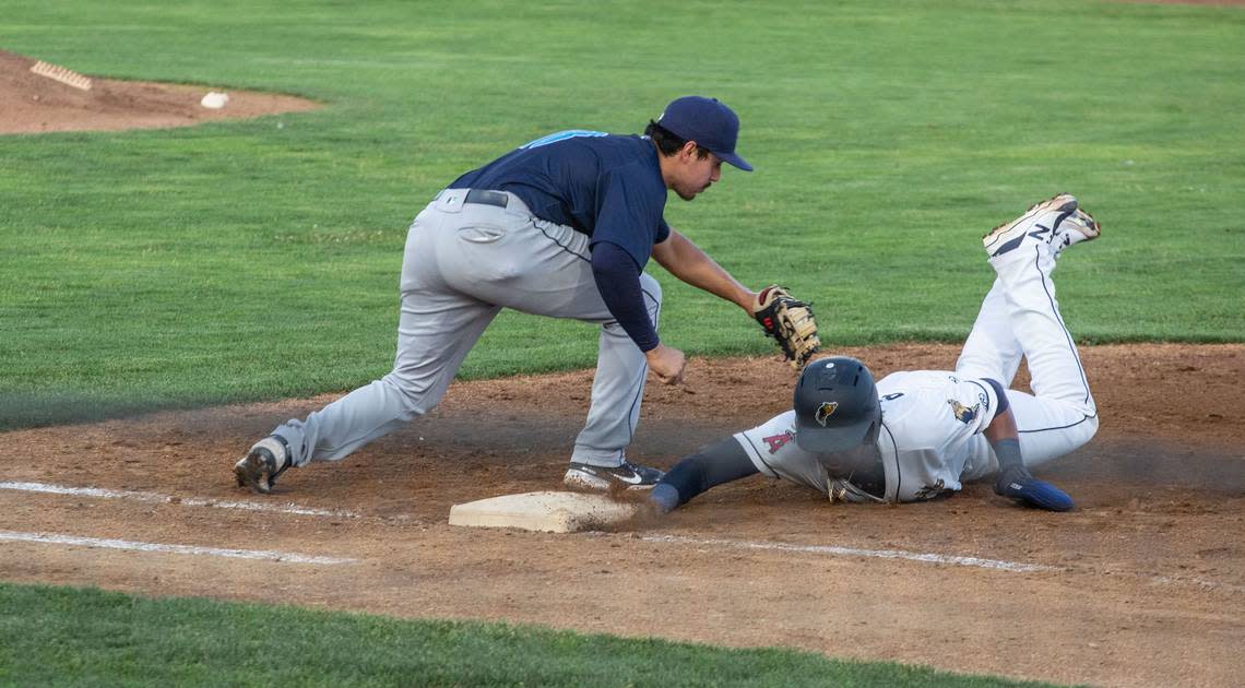 Tri-City Dust Devil Adrian Rondon (9) is safe as he slides back into first after trying to steal to second during the fifth inning of a game against the Everett AquaSox at Gesa Staidum in Pasco on June 24, 2021.