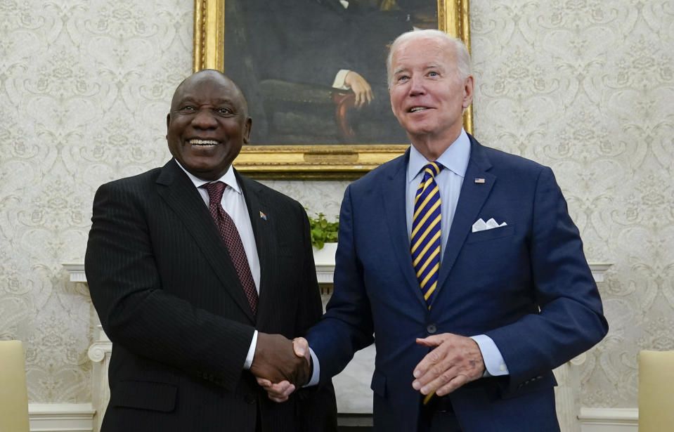 FILE - US President Joe Biden shakes hands with South African President Cyril Ramaphosa as they meet in the Oval Office of the White House, Friday, Sept. 16, 2022, in Washington. A bipartisan group of U.S. lawmakers wants the Biden Administration to punish South Africa for what they call its support for Russia's illegal invasion of Ukraine by relocating this year's AGOA America-Africa trade meeting to another country.(AP Photo/Alex Brandon/File)
